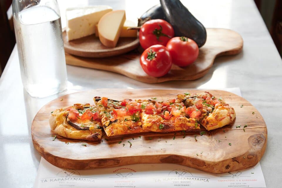 Feta cheese pie with eggplant, tomato and smoked cheese, just baked in the stone oven, at Karamanlidika Food Artistry restaurant, on 119 Ermou str., in Athens.