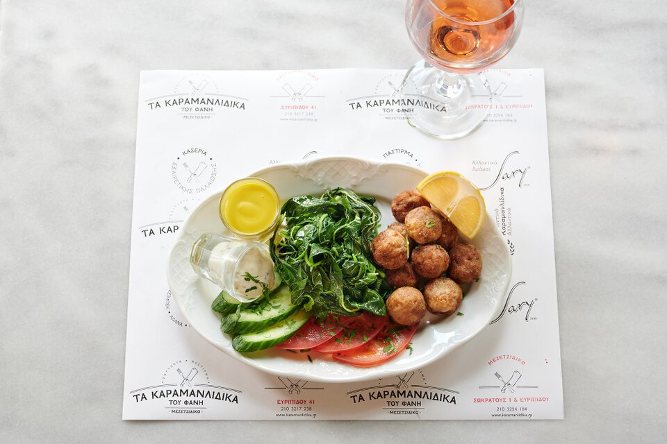 Chesme kiofte fried meatballs, with boiled leaf vegetables. A main course at Karamanlidika Food-Artistry restaurant, on Ermou street, in Athens.